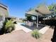 Outdoor kitchen and bar area poolside provide ultimate entertaining in this desert backyard at 8343 E Edward Ave, Scottsdale, AZ 85250