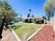 Spacious backyard featuring a pool, lush lawn, and covered patio, perfect for outdoor entertaining at 8343 E Edward Ave, Scottsdale, AZ 85250