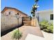Fenced backyard area with landscaping, walkway and gate at 8343 E Edward Ave, Scottsdale, AZ 85250