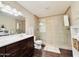 Bright bathroom features a double vanity and glass enclosed shower at 8343 E Edward Ave, Scottsdale, AZ 85250
