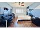 Bedroom features stylish blue accent wall, modern ceiling fan and wood-look floors at 8343 E Edward Ave, Scottsdale, AZ 85250