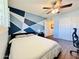This bedroom features geometric blue accent wall and ceiling fan at 8343 E Edward Ave, Scottsdale, AZ 85250