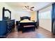 Bedroom features wood-look floors, ceiling fan, and bright window at 8343 E Edward Ave, Scottsdale, AZ 85250