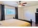 Bedroom featuring wood-look floors, ceiling fan, and natural light at 8343 E Edward Ave, Scottsdale, AZ 85250