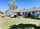 Charming single-story home featuring a well-manicured lawn and mature landscaping at 8343 E Edward Ave, Scottsdale, AZ 85250