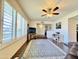 Spacious living room with plantation shutters, ceiling fan, and hardwood floors at 8343 E Edward Ave, Scottsdale, AZ 85250
