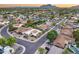 Neighborhood aerial view with desert landscaping, lush green trees and mountain views under a picturesque sunset sky at 8618 E Via De Encanto --, Scottsdale, AZ 85258