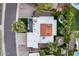 A bird's-eye view showcases a unique home with a combination of a flat roof and red brick pitched roof, accented by lush landscaping at 8618 E Via De Encanto --, Scottsdale, AZ 85258