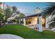 Covered backyard patio with white furniture and string lights, creating an inviting outdoor living space at 8618 E Via De Encanto --, Scottsdale, AZ 85258