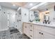 Bright bathroom featuring dual sinks, marble countertops, and a glass enclosed walk-in shower at 8618 E Via De Encanto --, Scottsdale, AZ 85258