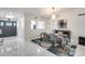 Contemporary dining room with modern light fixture, marble floors, and an open view into the kitchen area at 8618 E Via De Encanto --, Scottsdale, AZ 85258