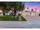 Charming single-story home with a modern design, lush lawn and three car garage at 8618 E Via De Encanto --, Scottsdale, AZ 85258