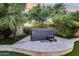 Backyard hot tub on a tiled patio with tropical landscaping and lush green lawn, perfect for relaxation at 8618 E Via De Encanto --, Scottsdale, AZ 85258