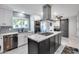 Modern eat-in kitchen featuring marble countertops, an island cooktop, stainless steel appliances, and custom cabinets at 8618 E Via De Encanto --, Scottsdale, AZ 85258