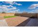 A view of the backyard showing the brick patio and the easy to maintain landscape at 9155 W Minnezona Ave, Phoenix, AZ 85037