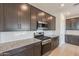 Gourmet kitchen featuring stainless steel appliances, subway tile backsplash, and granite countertops at 9155 W Minnezona Ave, Phoenix, AZ 85037