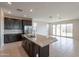 Open kitchen design with a large granite island and views of the adjacent living area at 9155 W Minnezona Ave, Phoenix, AZ 85037