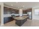 Modern kitchen with granite countertops, stainless steel appliances, and dark wood cabinets at 9155 W Minnezona Ave, Phoenix, AZ 85037