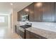 Sleek kitchen with stainless steel appliances, granite counters, and plentiful cabinet storage at 9155 W Minnezona Ave, Phoenix, AZ 85037