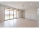Bright and spacious living room featuring tile floors and sliding glass doors to the backyard at 9155 W Minnezona Ave, Phoenix, AZ 85037