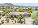 Desert home with solar panels, tile roof, desert landscaping and a three car garage at 9421 E Calle De Valle Dr, Scottsdale, AZ 85255