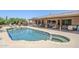 Backyard with a swimming pool, covered patio, outdoor kitchen, lounge chairs and desert landscape at 9421 E Calle De Valle Dr, Scottsdale, AZ 85255