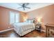 Bedroom with plantation shutters, wood floors, ceiling fan, and stylish decor at 9421 E Calle De Valle Dr, Scottsdale, AZ 85255