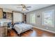Comfortable bedroom with Murphy bed, desk, shelving, and wood floors at 9421 E Calle De Valle Dr, Scottsdale, AZ 85255