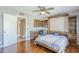 Comfortable bedroom with desk area and murphy bed featuring wood cabinets, light ceiling fan, and hardwood floors at 9421 E Calle De Valle Dr, Scottsdale, AZ 85255