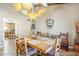Charming dining area with a large wooden table and unique overhead lighting fixture at 9421 E Calle De Valle Dr, Scottsdale, AZ 85255