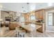 Spacious kitchen featuring a large island, granite countertops, and a seamless transition to the living area at 9421 E Calle De Valle Dr, Scottsdale, AZ 85255