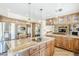 Well-equipped kitchen showcasing stainless steel appliances, wooden cabinetry, and a granite-topped island at 9421 E Calle De Valle Dr, Scottsdale, AZ 85255