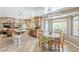 Open kitchen and dining area with a large island, casual seating, and a view of the backyard at 9421 E Calle De Valle Dr, Scottsdale, AZ 85255