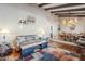 Cozy living room with a sofa, stylish coffee table, and a view into the dining area at 9421 E Calle De Valle Dr, Scottsdale, AZ 85255