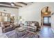 Comfortable living room with high ceilings, tile floors, and a doorway to the kitchen at 9421 E Calle De Valle Dr, Scottsdale, AZ 85255
