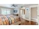 Comfortable main bedroom with ceiling fan, wood floors, and sliding barn door to the bathroom at 9421 E Calle De Valle Dr, Scottsdale, AZ 85255