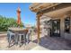 Outdoor kitchen with tile flooring, stainless steel grill, sink, bar and seating for entertaining at 9421 E Calle De Valle Dr, Scottsdale, AZ 85255