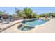 Sparkling pool and spa surrounded by lush landscaping, mature trees, and lounge chairs in the backyard at 9421 E Calle De Valle Dr, Scottsdale, AZ 85255