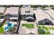 Aerial view of the home's backyard featuring hardscape, a patch of grass, and proximity to the pool at 10036 E Naranja Ave, Mesa, AZ 85209