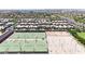 An aerial view showing community sports courts, and nearby single Gathering homes at 10036 E Naranja Ave, Mesa, AZ 85209