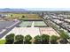 Aerial view showcasing community sports courts, baseball field, and residential area at 10036 E Naranja Ave, Mesa, AZ 85209