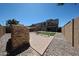 Backyard featuring an outdoor fireplace, playground, pavers, artificial grass, and rock landscaping at 10036 E Naranja Ave, Mesa, AZ 85209