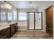 Bright bathroom features tile floors, soaking tub, walk-in shower with glass door, and double sink vanity at 10036 E Naranja Ave, Mesa, AZ 85209