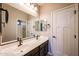 Elegant bathroom featuring dual sinks, modern fixtures, and a large mirror enhancing the space at 10036 E Naranja Ave, Mesa, AZ 85209