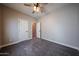 Neutral bedroom featuring plush carpeting, fresh paint, a ceiling fan, and ample natural light at 10036 E Naranja Ave, Mesa, AZ 85209