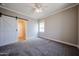 Cozy bedroom with plush carpeting, fresh paint, a sliding barn door, and ample natural light at 10036 E Naranja Ave, Mesa, AZ 85209