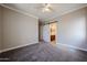 Comfortable bedroom features plush carpeting, fresh paint, a barn door to the bath, and ample light at 10036 E Naranja Ave, Mesa, AZ 85209