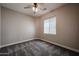 Comfortable bedroom with plush carpeting, fresh paint, a ceiling fan, and ample natural light at 10036 E Naranja Ave, Mesa, AZ 85209