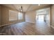 Dining room featuring wood-look tile flooring, modern lighting, and ample natural light from a large window at 10036 E Naranja Ave, Mesa, AZ 85209