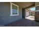 Covered front porch offers shelter and style with its brick floor and view of the garage at 10036 E Naranja Ave, Mesa, AZ 85209